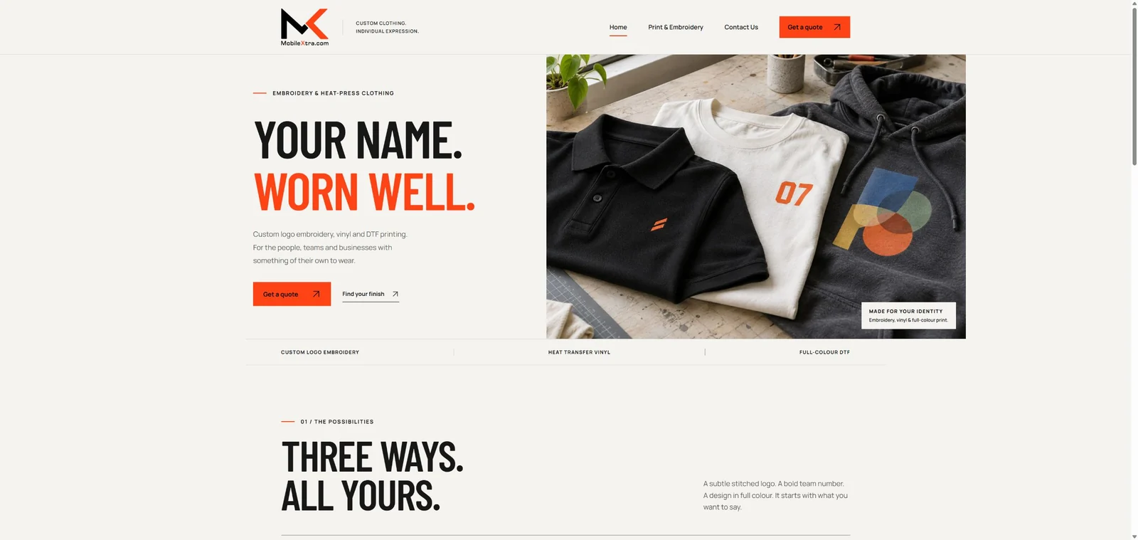 MobileXtra homepage with bold orange lettering and embroidered and printed clothing